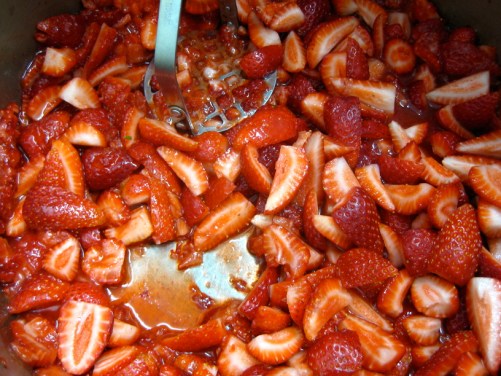 Mashing strawberries to make strawberry jam