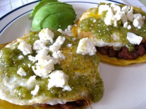 Huevos Rancheros with beans, tomatillo salsa, avocado, and queso fresco