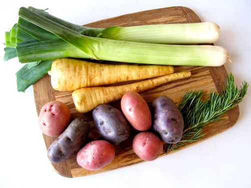 New potatoes, purple potatoes, parsnips, and leeks for roasting