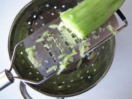 Grating the cucumber for Tzatziki