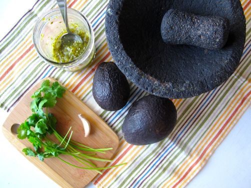Volcanic rock molcajete, avocados, cilantro, garlic, and roasted tomatillo salsa Volcanic rock molcajete, avocados, cilantro, garlic, and roasted tomatillo salsa