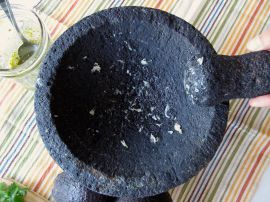 Grinding garlic in the molcajete Grinding garlic in the molcajete