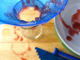 Canning the rhubarb jam: hot jam gels nicely on a cool dish
