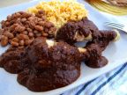 Mole Poblano with chicken, pinto beans, and Spanish rice