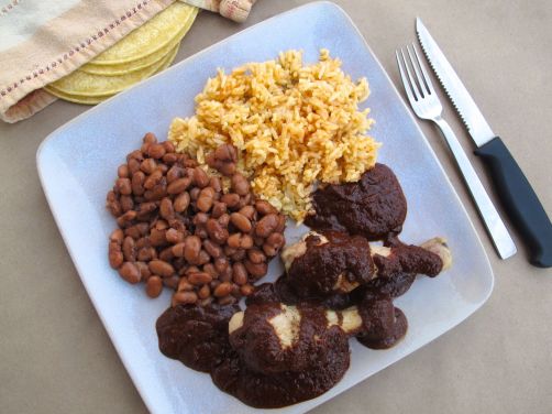 Mole Poblano with chicken, pinto beans, and Spanish rice Mole Poblano with chicken, pinto beans, and Spanish rice