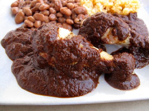 Mole Poblano with chicken, pinto beans, and Spanish rice Mole Poblano with chicken, pinto beans, and Spanish rice
