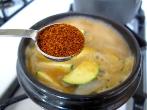 Adding kochukaru to Doenjang Jjigae (Savory Korean Stew) Adding kochukaru to Doenjang Jjigae (Savory Korean Stew)