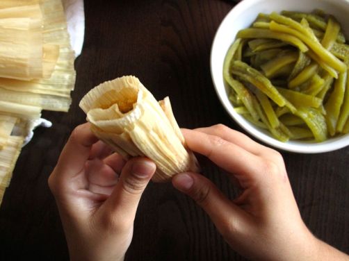 Folding up the end of the tamales