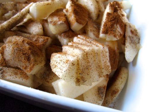 Making Pear Cranberry Crisp with cardamom and cinnamon