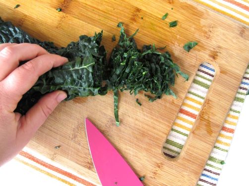 Shredding kale for Tuscan Kale Salad