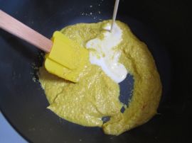 Adding the blended peanut butter and coconut milk to the simmered aromatics