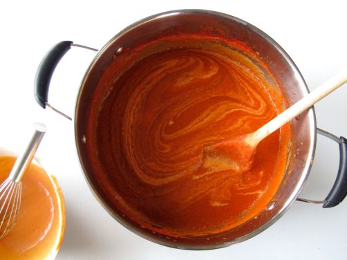 Swirling tempered Greek yogurt into Spicy Tomato Soup