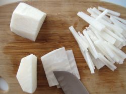 Julienning the peeled daikon radish