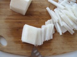 Julienning the peeled daikon radish